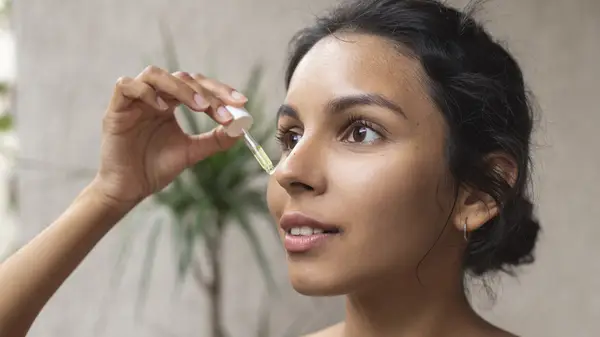 Woman applying serum