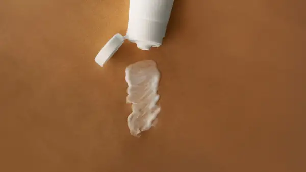 A tube of toothpaste on skin