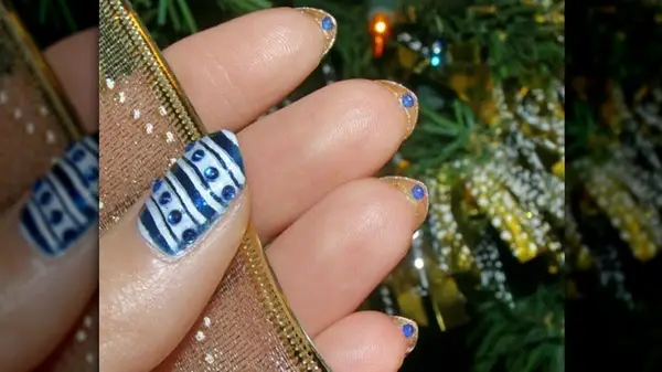 Gold underside mani with blue rhinestones