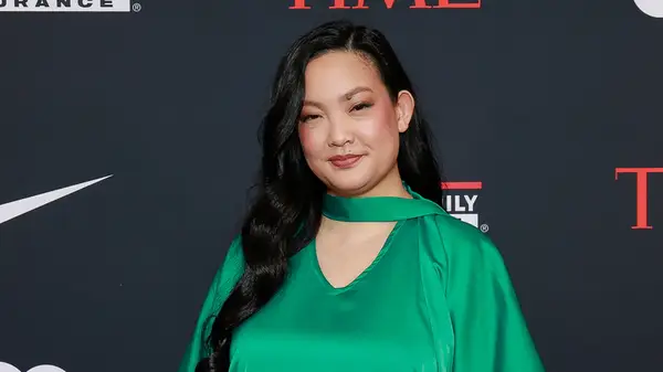 Amanda Nguyen at an event with a soft smile in a green dress
