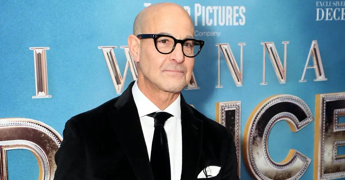 Stanley Tucci sorrindo no tapete vermelho da estreia de um filme