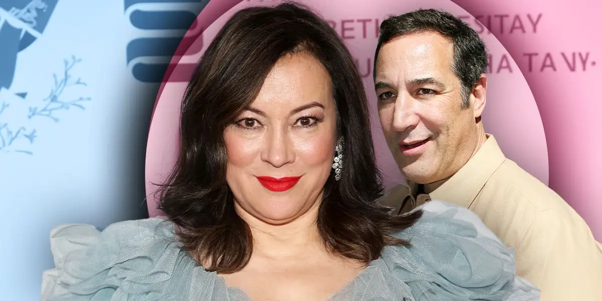 Homer Simpson lächelt und hält eine schwarze Mütze mit Mickey-Ohren in die Luft.