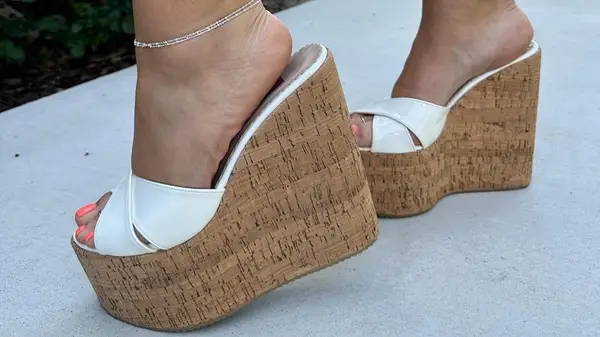 A person in chunky wedges