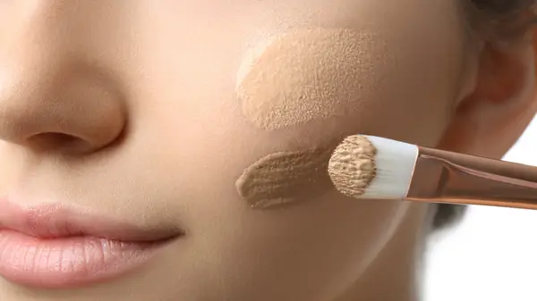 Woman applying foundation
