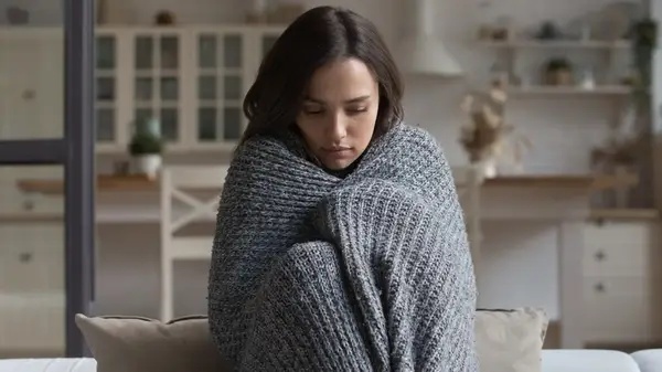 A woman wrapped in a blanket