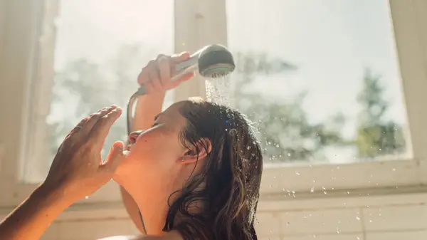 Woman washing her hair in the shower