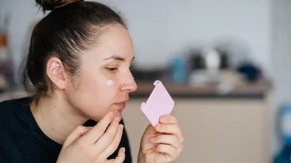A woman exfoliating her skin