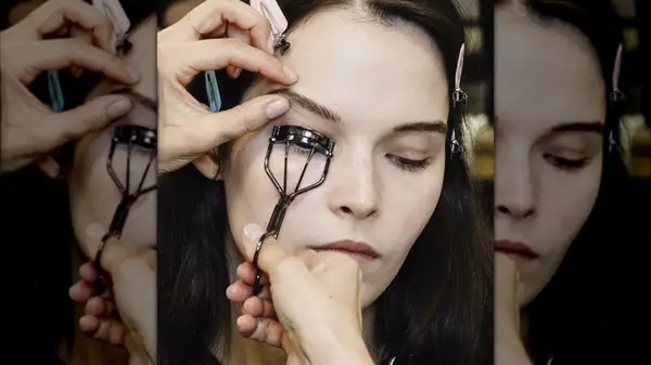 Model uses eyelash curler