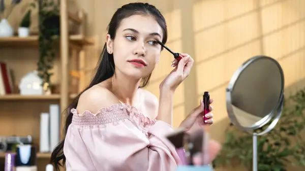 Woman applies mascara