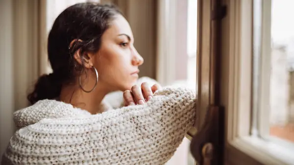 Woman looking out window