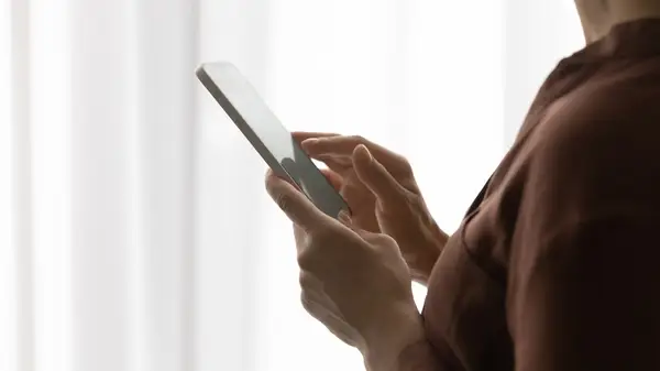 Woman swiping on cell phone