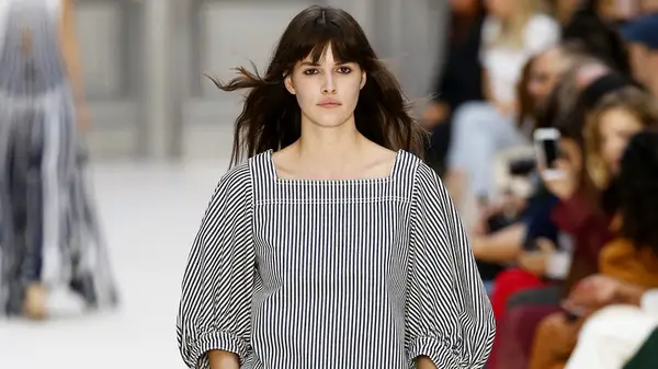 Woman walking runway in seersucker