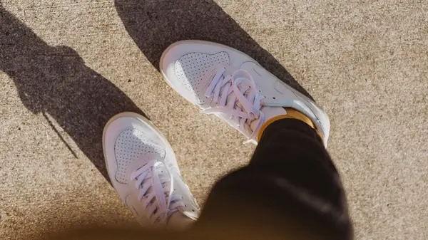 white sneakers outside in sun