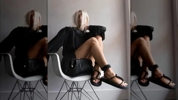 woman with black clutch on chair