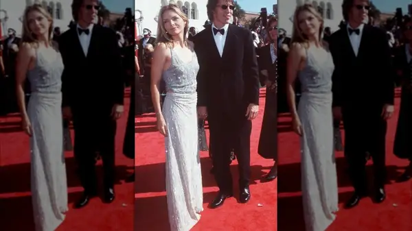 Michelle Pfeiffer on the red carpet in a silver dress with her partner