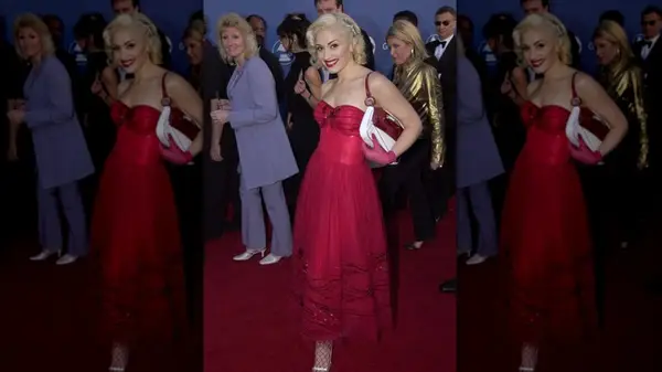 Gwen Stefani on the red carpet and wearing a red dress