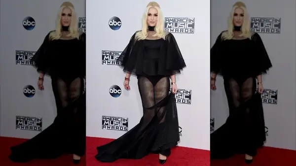 Gwen Stefani on the red carpet and wearing a sheer black dress