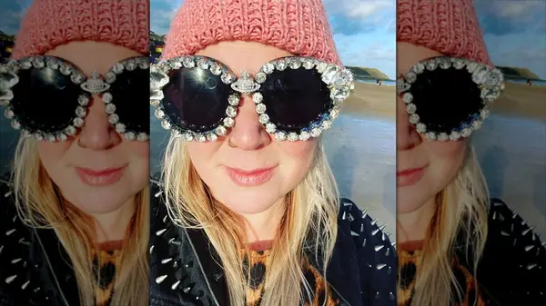 A woman wearing heavily embellished sunglasses