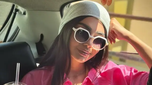 A woman in structured sunglasses