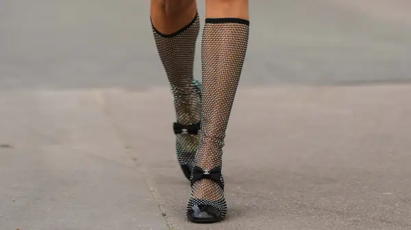 Feet with crystal mesh socks and Chanel shoes