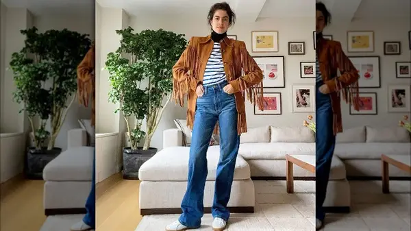 woman wearing jeans and fringe jacket