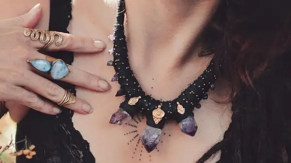 Person wearing necklace and rings