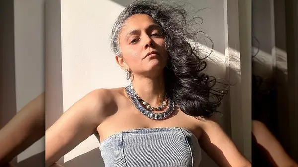 person wearing statement necklace