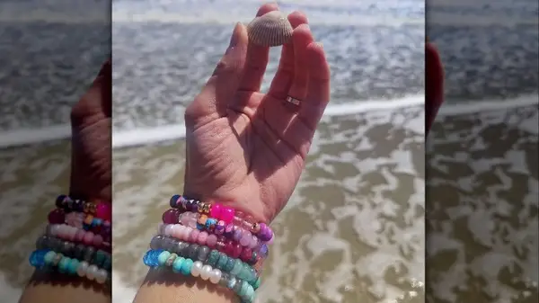 Hand with beaded bracelets 