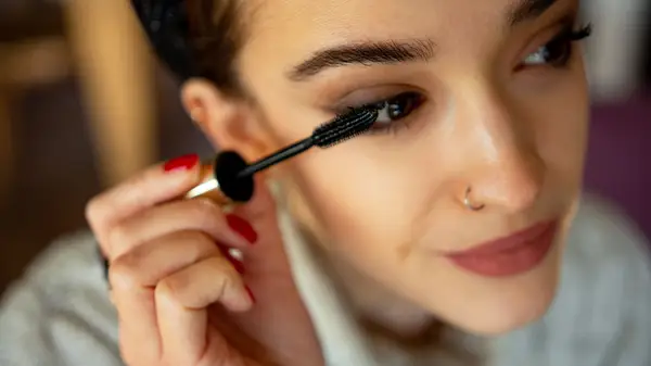 Person applying mascara