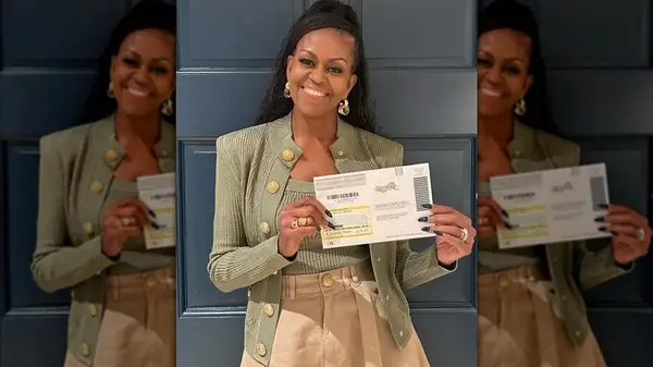 Michelle Obama holding a voter registration card