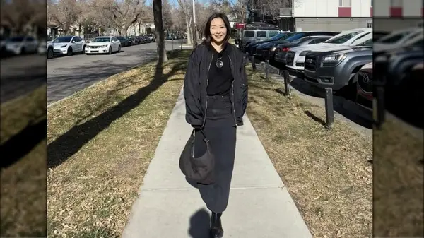 Woman posing for photo wearing denim skirt