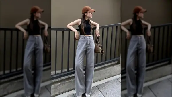 A woman with very high-rise gray jeans leaning on a railing