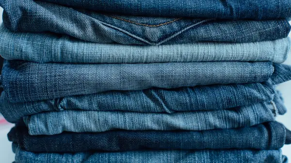 A stack of multi-colored blue jeans