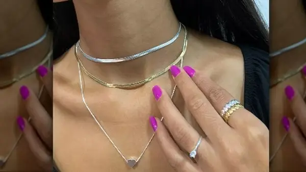 Person wearing mixed metal necklaces