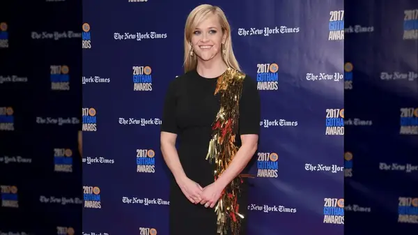Reese Witherspoon in a black dress with gold tinsel