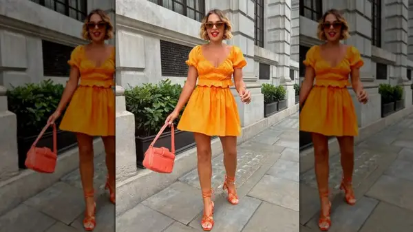A woman walking on the sidewalk in an all-orange outfit