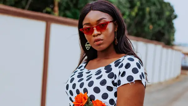 Woman wearing outdated polka dots and tomato red