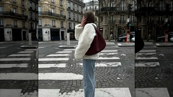 Woman carrying an oxblood bag
