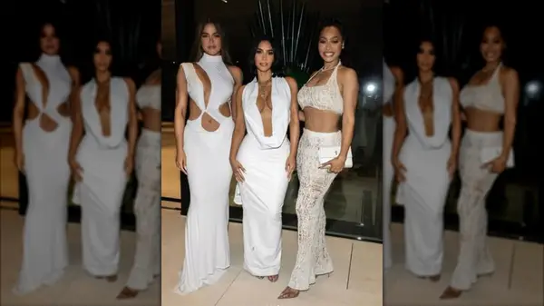 Kim Kardashian in an all-white look next to two women also wearing all-white looks