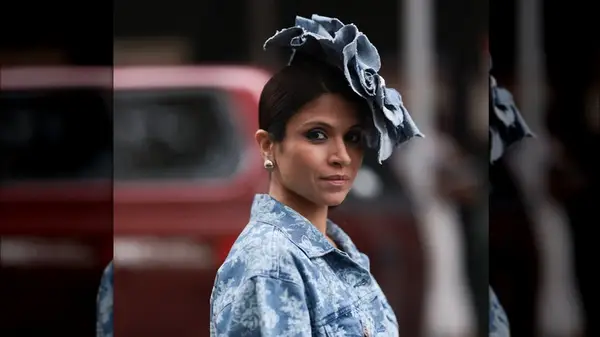 A woman wearing a denim headpiece 