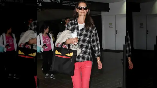 Katie Holmes wearing a plaid shirt and colorful jeans in 2014