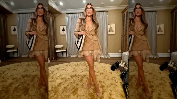 Jennifer Lopez in a tan blazer and mini skirt posing