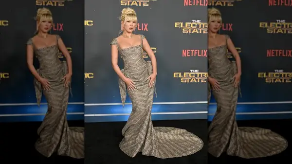 Millie Bobby Brown posing in an intricate dress at 