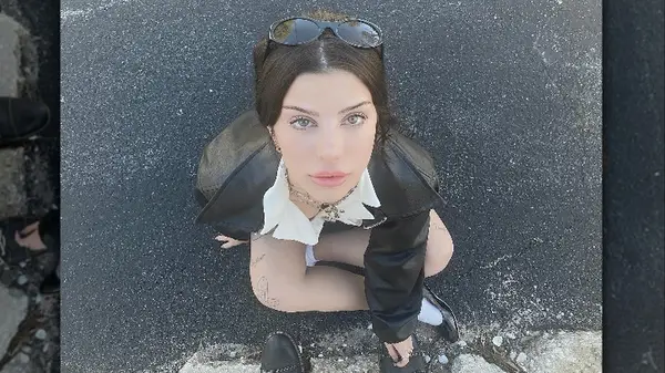 Woman sitting on pavement
