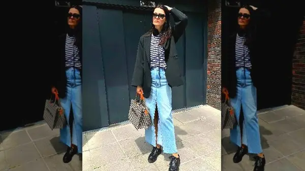 Person wearing long denim skirt