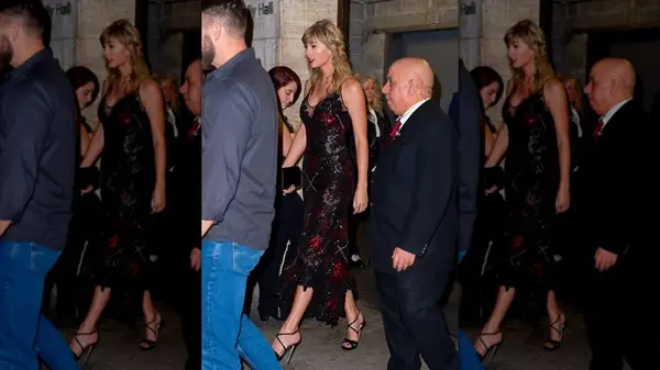 Paparazzi shot of Taylor Swift walking in a black dress