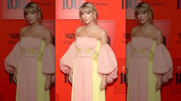 Taylor Swift wearing a pink and yellow gown on the red carpet