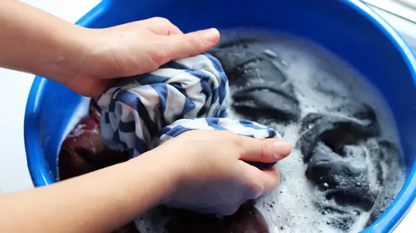 Woman hand washing clothes