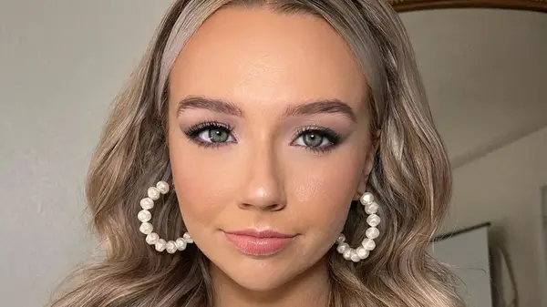 Woman wearing pearl hoops