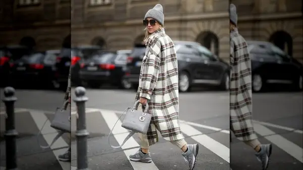 A woman wearing a long, grey shacket 